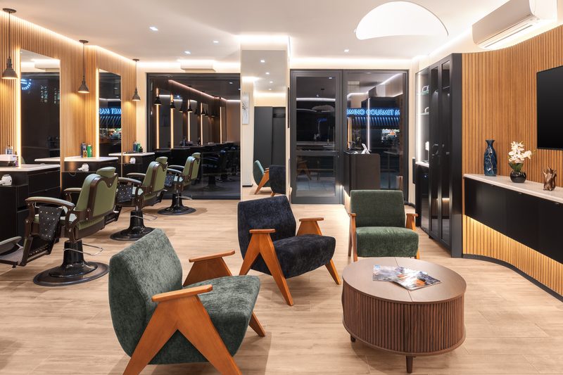 The whole room: lounge chairs, the row of barber chairs and the street outside